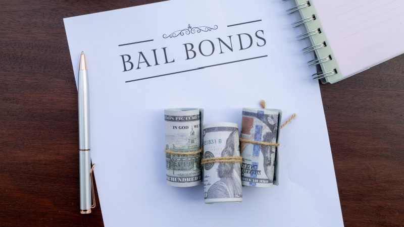 Bail bonds agreement document on desk representing how individuals charged with felony murder can be released pretrial